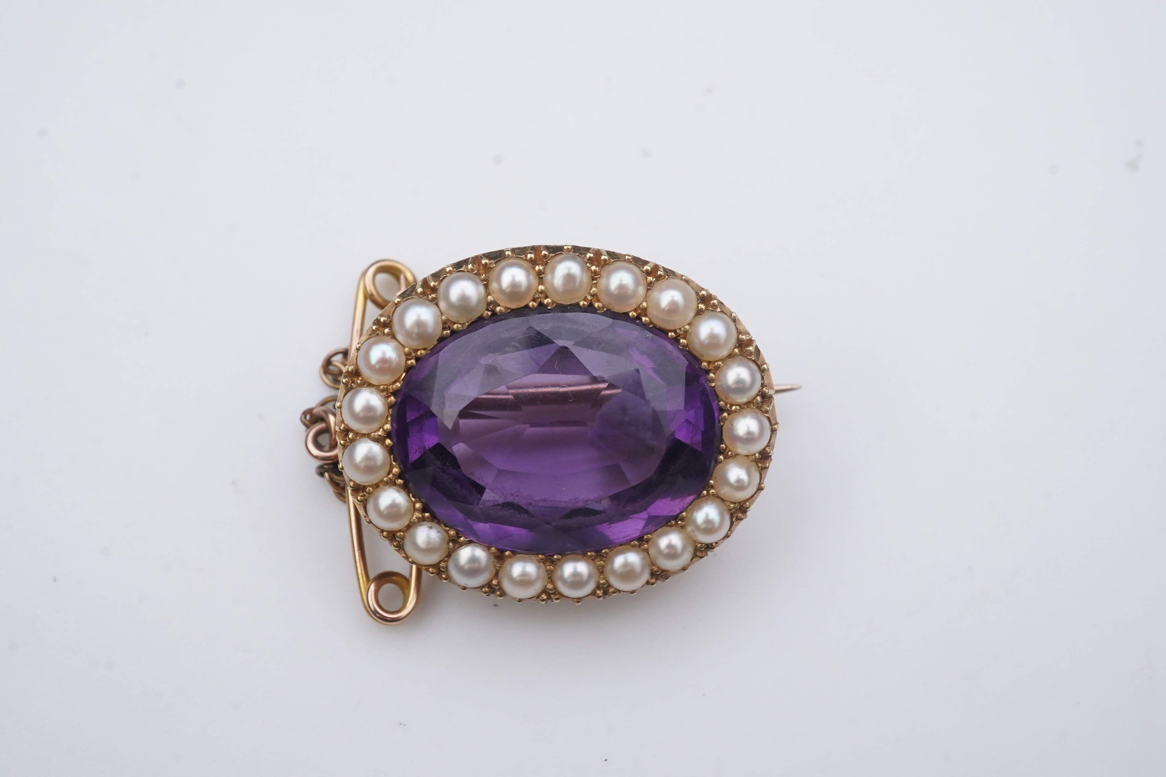 An amethyst and split pearl brooch, circa 1900